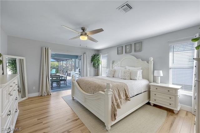 bedroom with multiple windows, access to exterior, light hardwood / wood-style flooring, and ceiling fan