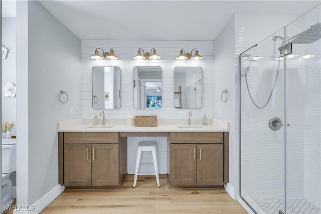 bathroom with vanity, hardwood / wood-style floors, and walk in shower