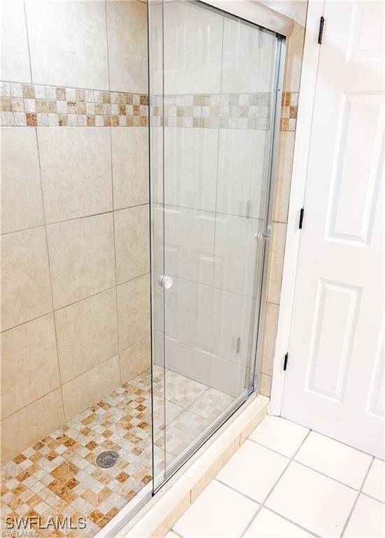 bathroom featuring tile patterned flooring and an enclosed shower