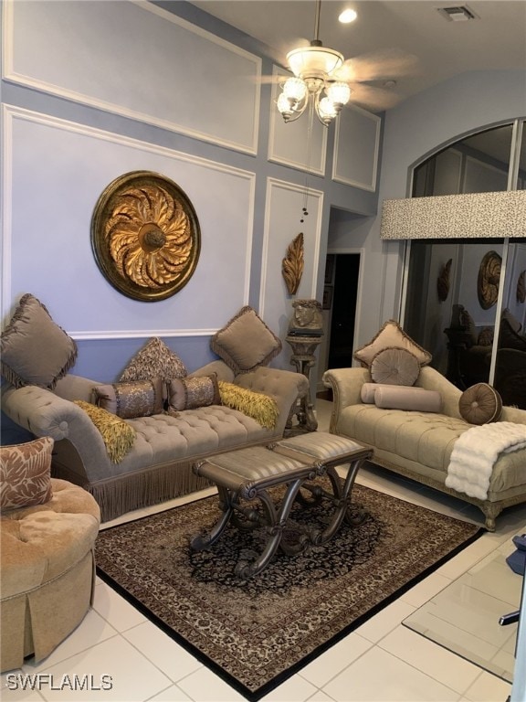 tiled living room featuring a chandelier