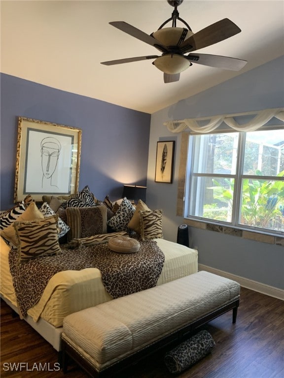 bedroom with vaulted ceiling, dark wood-type flooring, and ceiling fan