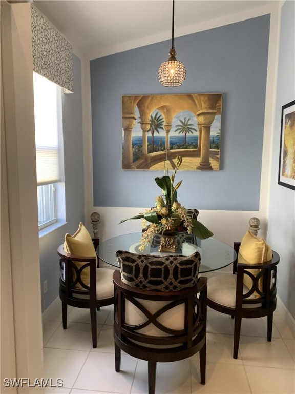 sitting room with lofted ceiling and light tile patterned floors