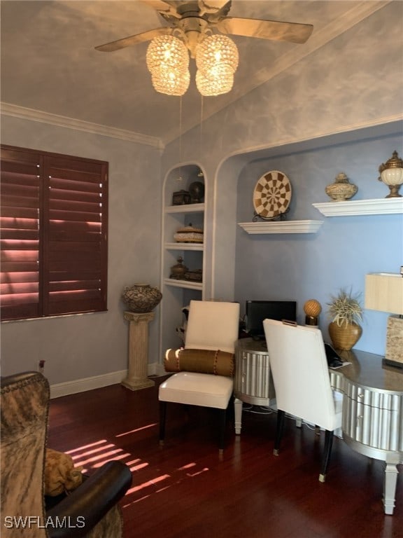 sitting room with crown molding, hardwood / wood-style flooring, built in features, ceiling fan, and vaulted ceiling