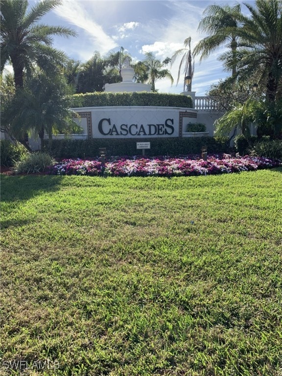 community / neighborhood sign with a yard