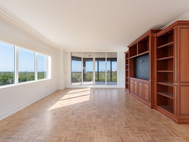 unfurnished living room with ornamental molding and light parquet flooring