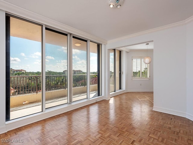 empty room featuring parquet flooring and ornamental molding
