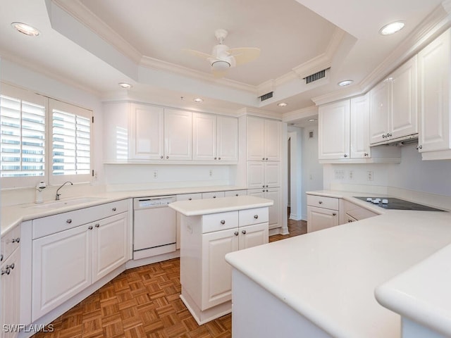 kitchen with white cabinetry, black electric cooktop, a tray ceiling, dishwasher, and a kitchen island