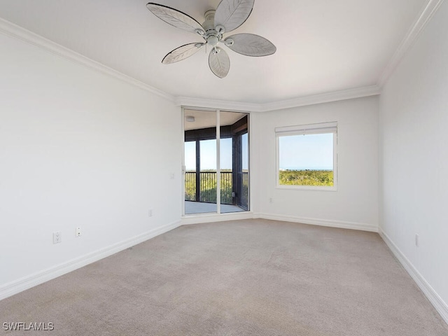empty room with crown molding, light carpet, and ceiling fan