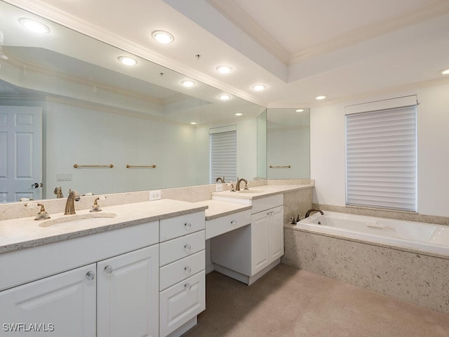 bathroom with tiled tub, a raised ceiling, vanity, and crown molding