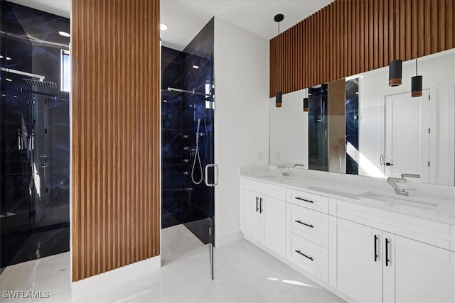 bathroom featuring a shower with door and vanity