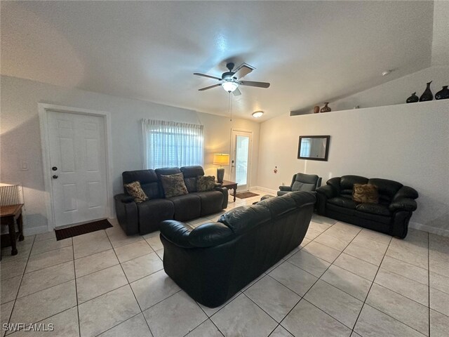 tiled living room with lofted ceiling and ceiling fan