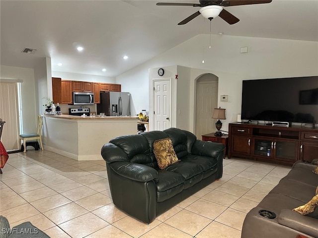 tiled living room featuring ceiling fan and lofted ceiling