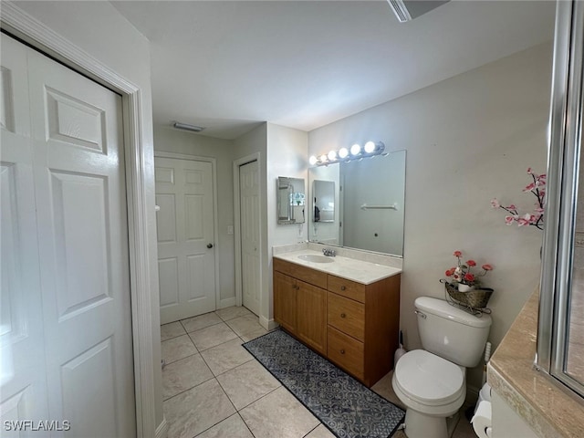 bathroom featuring tile patterned floors, visible vents, toilet, baseboards, and vanity