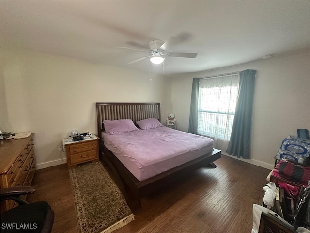 bedroom with ceiling fan, baseboards, and wood finished floors