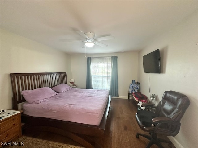 bedroom with baseboards, dark wood-type flooring, and ceiling fan