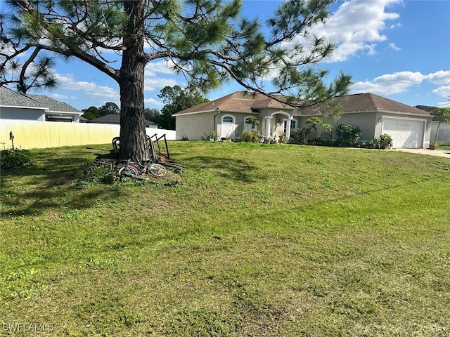 view of front facade with a garage and a front yard