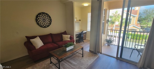 living room featuring hardwood / wood-style flooring and a healthy amount of sunlight