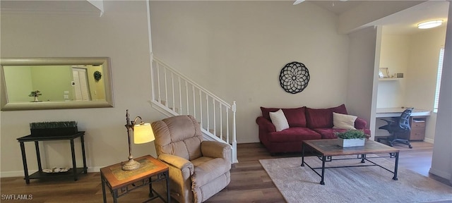 living area with stairs, baseboards, and wood finished floors