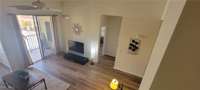 living room featuring wood-type flooring and ceiling fan