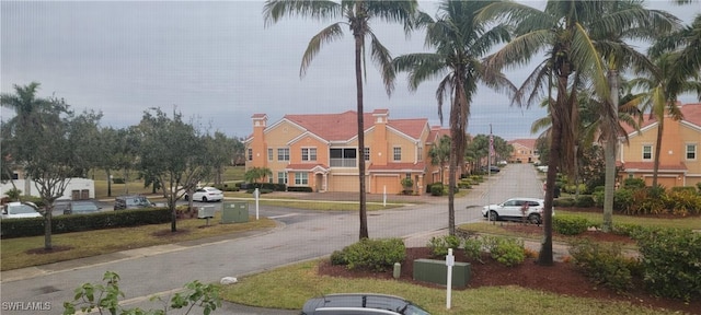 view of street featuring a residential view and curbs