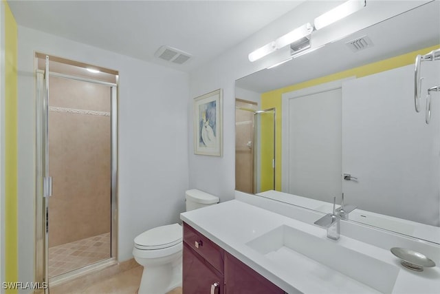 bathroom with vanity, a shower with shower door, and toilet