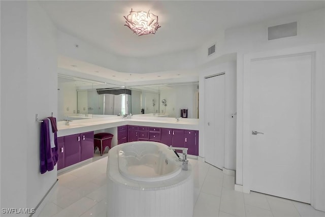 bathroom featuring vanity, a tub, and tile patterned floors