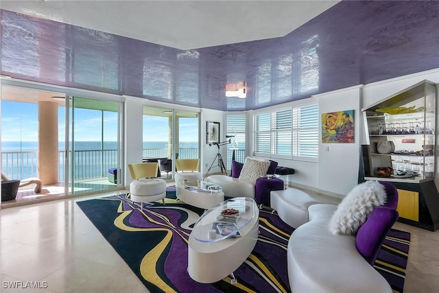 living room featuring floor to ceiling windows and a water view