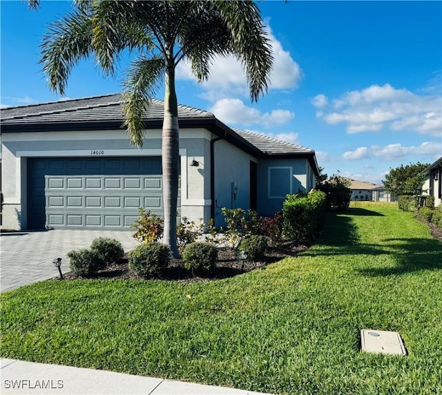 view of side of home featuring a garage and a yard