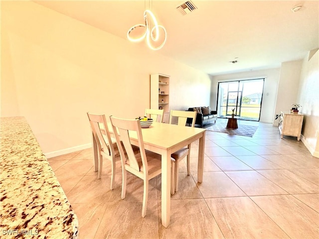 dining area featuring light tile patterned flooring