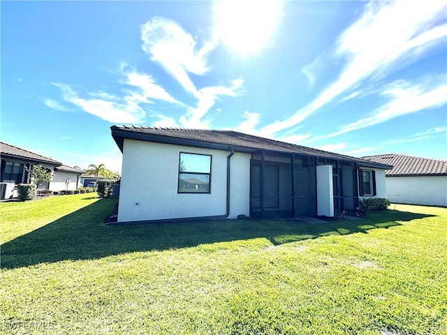 rear view of property with a yard and central AC unit