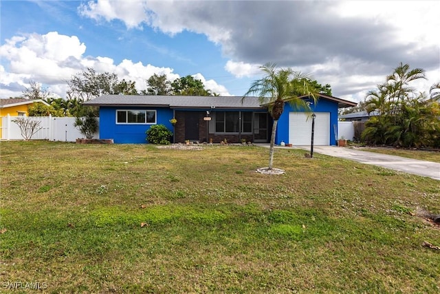 ranch-style home with a garage and a front lawn