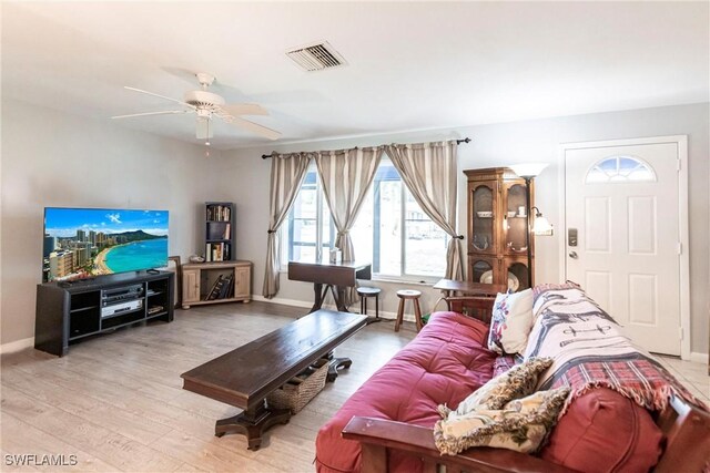 living room featuring ceiling fan and light hardwood / wood-style floors