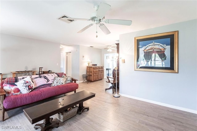 living room with ceiling fan and light wood-type flooring