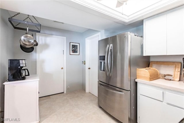 kitchen featuring white cabinets, stainless steel fridge, and ceiling fan