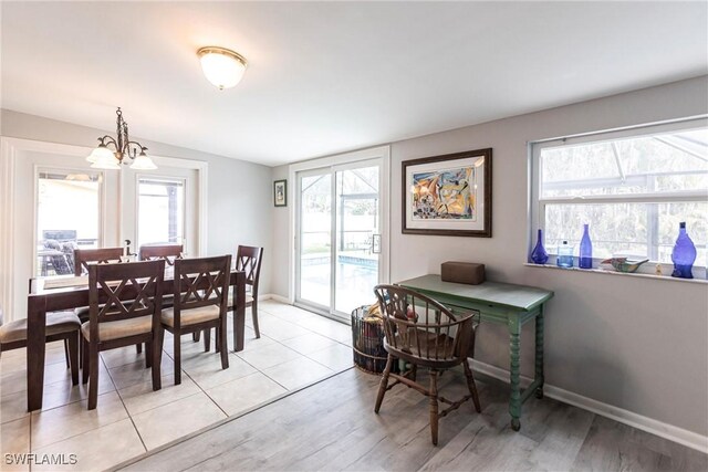 dining area featuring an inviting chandelier and light hardwood / wood-style floors