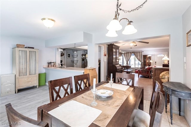 dining area with ceiling fan and light hardwood / wood-style floors