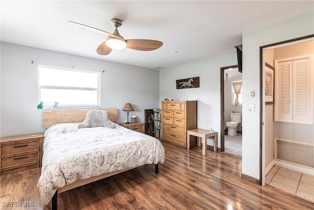 bedroom featuring ceiling fan, hardwood / wood-style floors, and ensuite bath