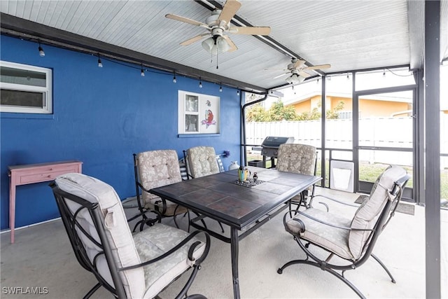 view of patio featuring outdoor dining space, grilling area, fence, and ceiling fan