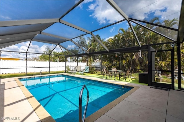 view of pool with a patio and a lanai