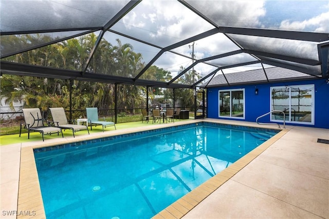 view of swimming pool with a patio area and glass enclosure