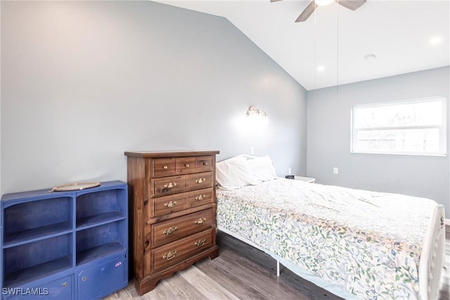 bedroom featuring hardwood / wood-style flooring, lofted ceiling, and ceiling fan