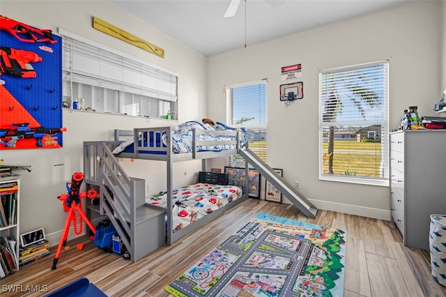 bedroom with ceiling fan and light hardwood / wood-style floors