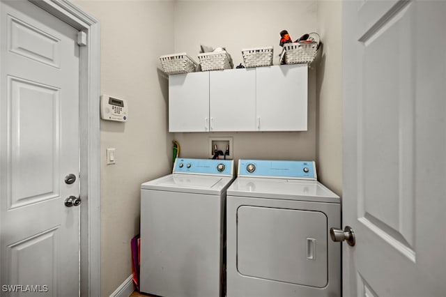 laundry room with cabinets and washer and dryer