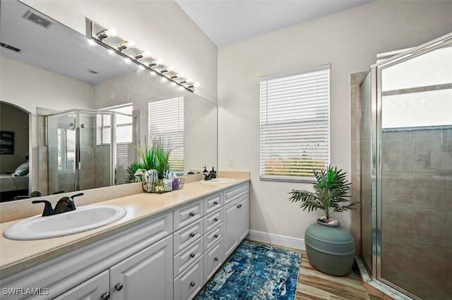 bathroom featuring vanity, hardwood / wood-style floors, and an enclosed shower