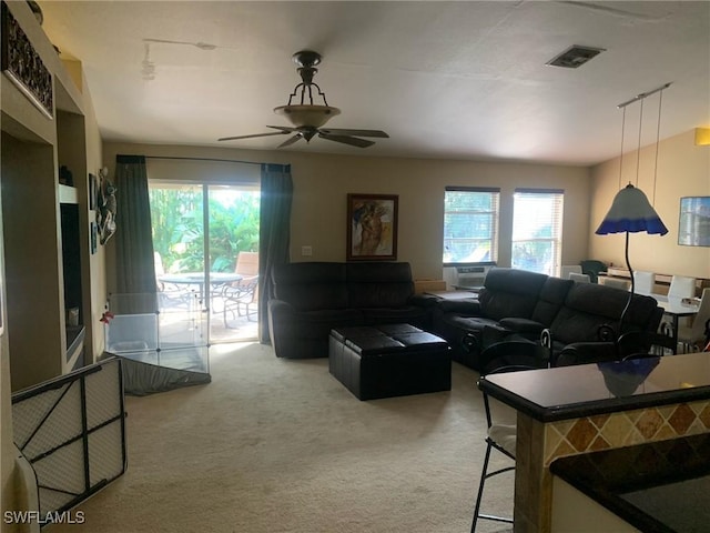 living room featuring carpet flooring and ceiling fan