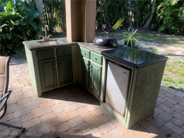 view of patio / terrace with area for grilling and sink