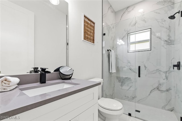 bathroom with vanity, toilet, and an enclosed shower