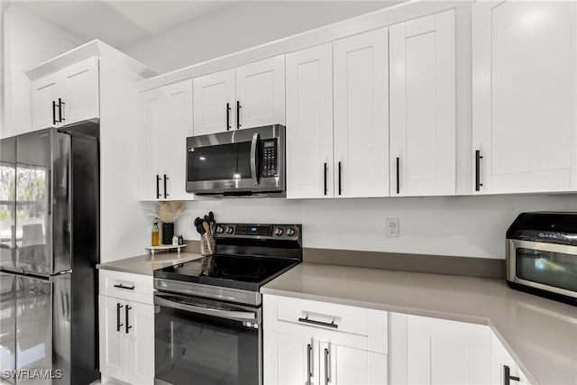 kitchen featuring white cabinetry and appliances with stainless steel finishes