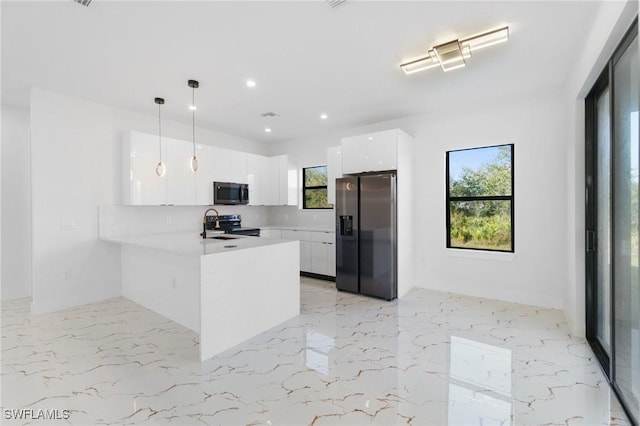 kitchen featuring white cabinets, refrigerator with ice dispenser, hanging light fixtures, electric range, and kitchen peninsula