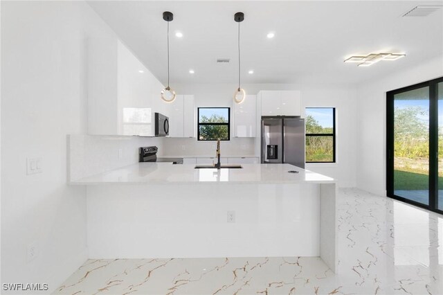 kitchen featuring pendant lighting, black appliances, white cabinetry, sink, and kitchen peninsula